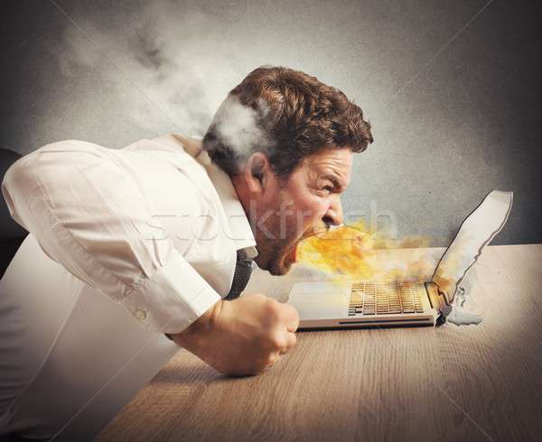 Angry businessman spits fire Stock photo © alphaspirit