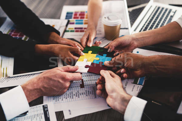 Stock photo: Teamwork of partners. Concept of integration and startup with puzzle pieces