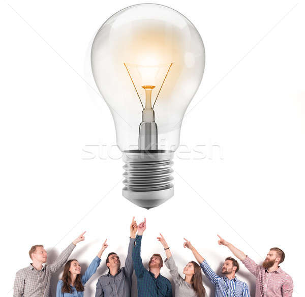 Brainstorming concept with businessmen that indicate an a lamp. Concept of idea and company startup Stock photo © alphaspirit