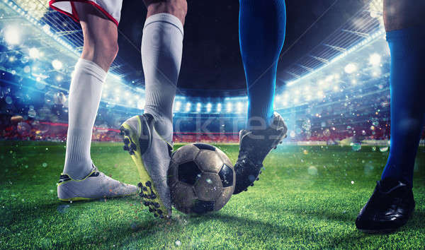 Stock photo: Soccer players with soccerball at the stadium during the match