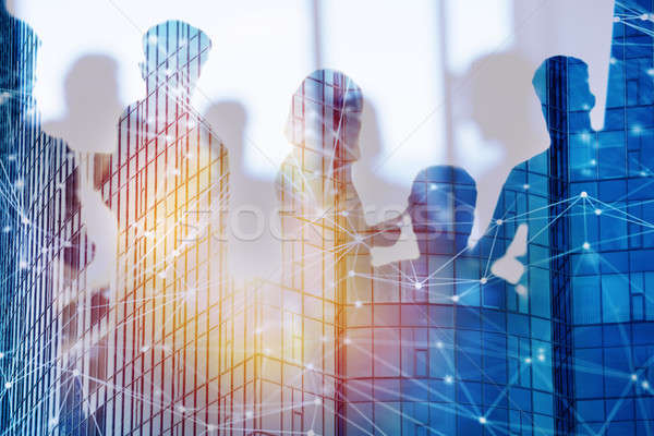 Businessmen that work together in office with network effect. Concept of teamwork and partnership. d Stock photo © alphaspirit