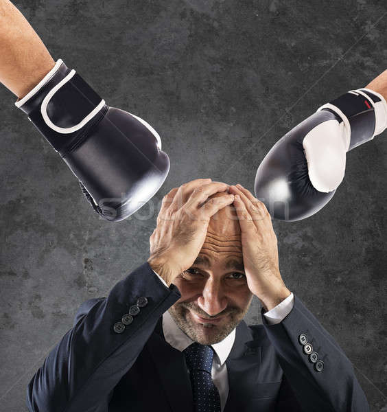 Businessman receives fists from competitors. concept of difficult career Stock photo © alphaspirit