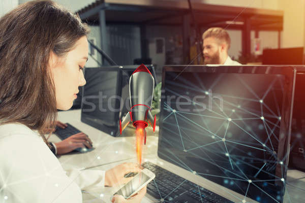 Businessperson in office work for a startup of a company with a rocket Stock photo © alphaspirit