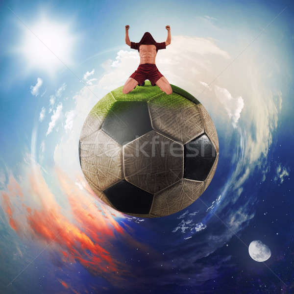Football player exults in a soccer ball planet Stock photo © alphaspirit