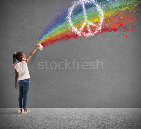 Child draws with spray the color of peace Stock photo © alphaspirit