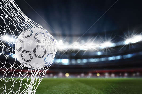 Stock photo: Soccer ball scores a goal on the net. 3D Rendering