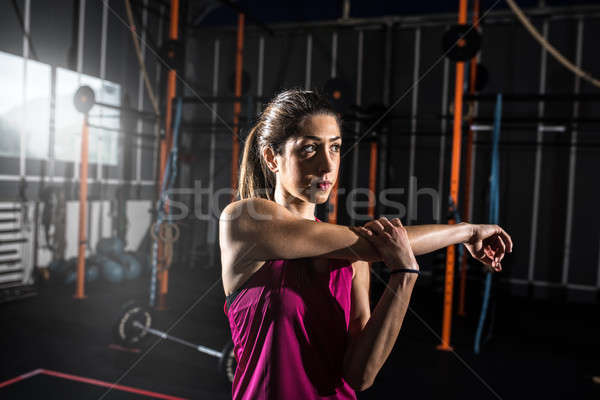 Athletic girl does stretching exercises at the gym Stock photo © alphaspirit