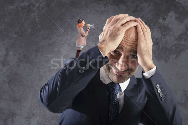 Clown that shuts with megaphone to a businessman Stock photo © alphaspirit