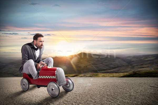 Stock photo: Businessman runs with his car on the road