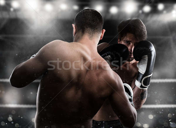 Boxer in a boxe competition beats his opponent Stock photo © alphaspirit