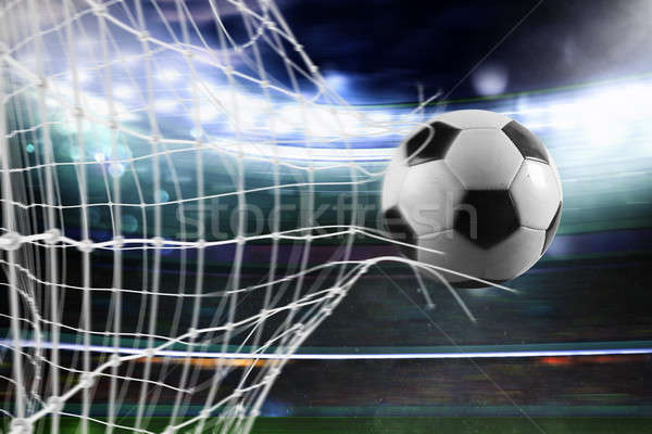 Soccer ball scores a goal on the net Stock photo © alphaspirit