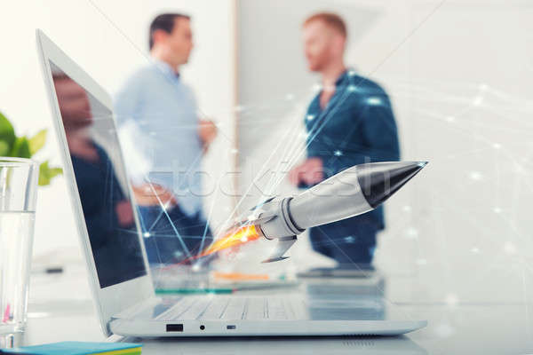 Businessperson in office work for a startup of a company with a rocket Stock photo © alphaspirit