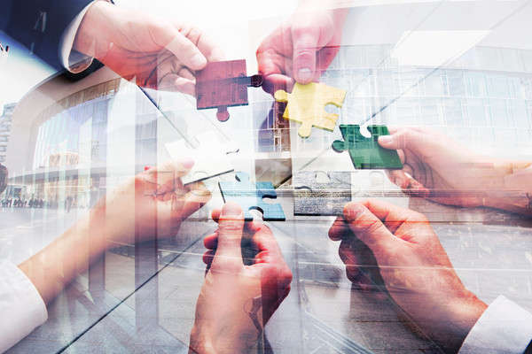 Stock photo: Teamwork of partners. Concept of integration and startup with puzzle pieces. double exposure