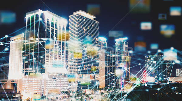 Abstract internet connection network with night city with skyscrapers at the background Stock photo © alphaspirit