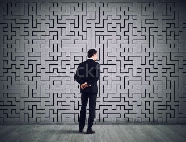 Businessman draws the solution of a labyrinth. Concept of problem solving Stock photo © alphaspirit