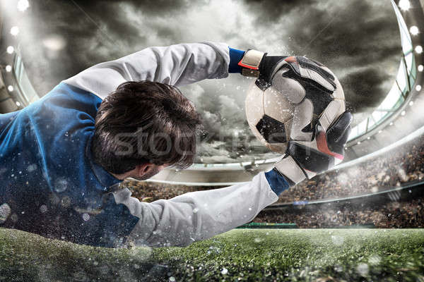 Goalkeeper catches the ball in the stadium Stock photo © alphaspirit