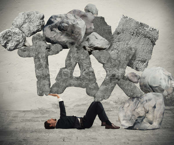 Crushed by the weight of taxes Stock photo © alphaspirit