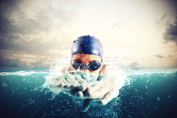 Athlete swims in a blue deep water Stock photo © alphaspirit