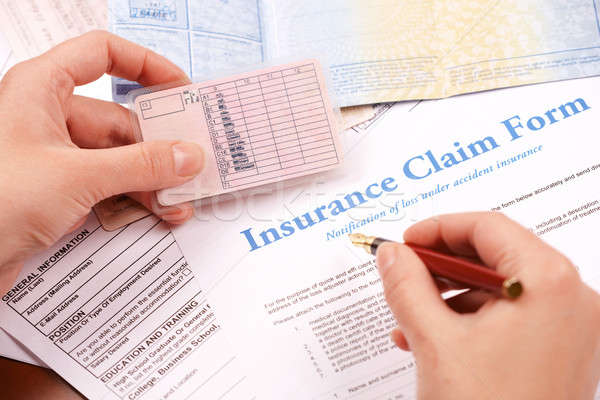 Stock photo: hand filling in insurance claim form
