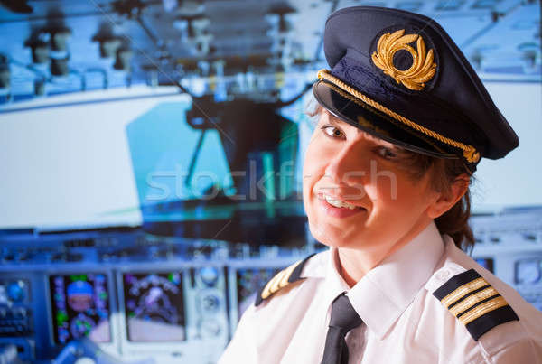 Légitársaság pilóta gyönyörű nő visel egyenruha kalap Stock fotó © Amaviael