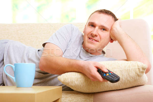 Smiling man watching television Stock photo © Amaviael