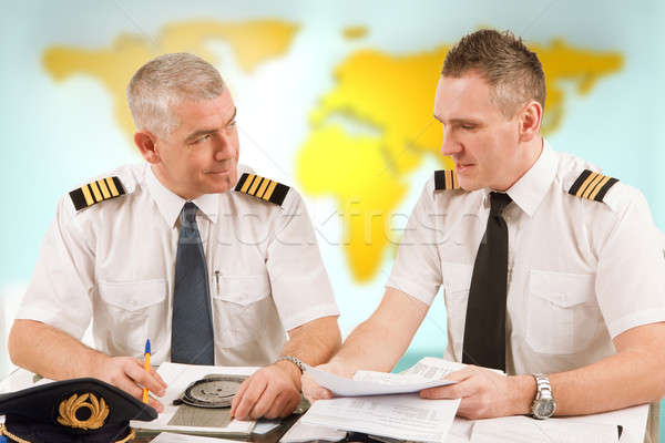 Airline pilots filling in papers in ARO Stock photo © Amaviael