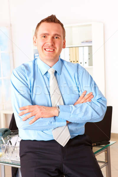 Stock photo: Happy businessman leaning on office desk