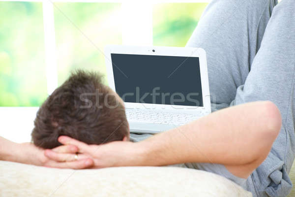 Man relaxing with laptop Stock photo © Amaviael