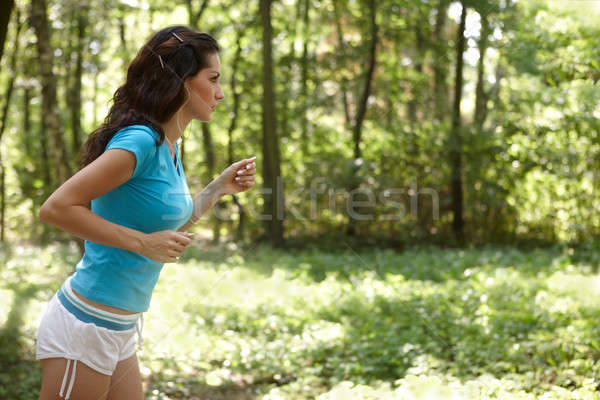 Fiatal nő fut park zenét hallgat lány nők Stock fotó © Amaviael