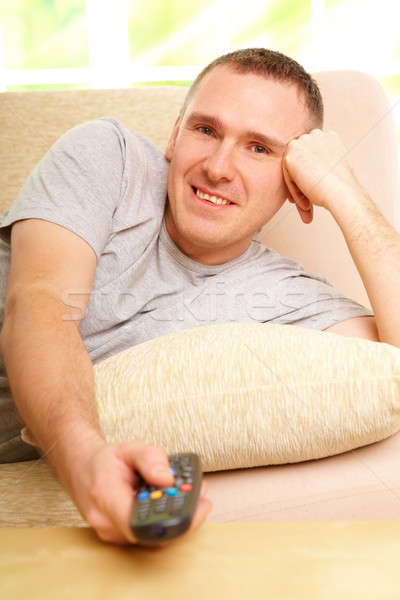 Smiling man watching television Stock photo © Amaviael