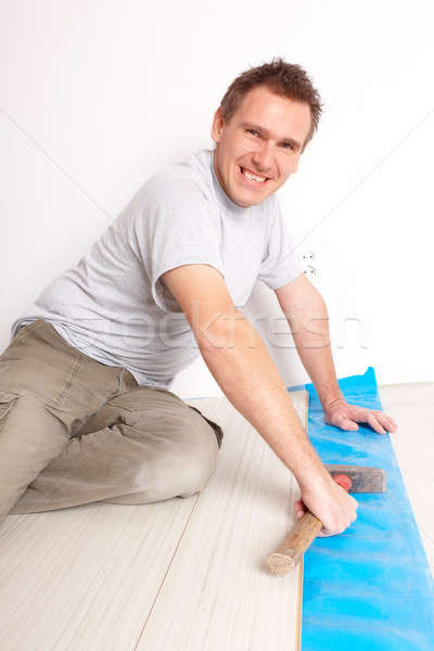 Worker installing a laminated flooring Stock photo © Amaviael