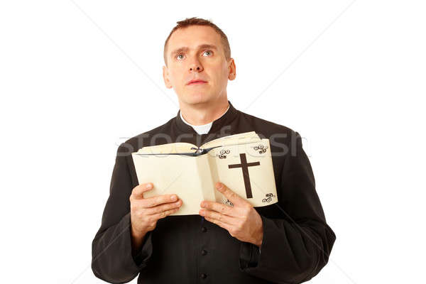 Jóvenes sacerdote Biblia manos mirando lectura Foto stock © Amaviael