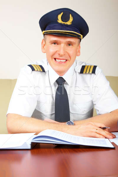 Airline pilot filling in papers in ARO Stock photo © Amaviael