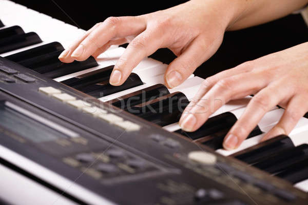 Woman's hands playing music on the piano Stock photo © Amaviael