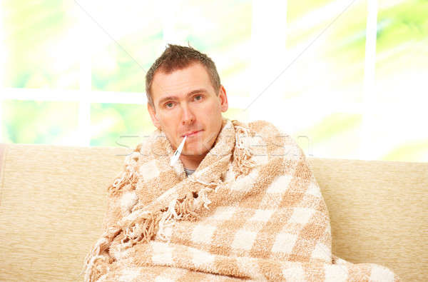 Uomo febbre freddo seduta divano Foto d'archivio © Amaviael