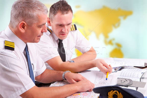 Airline pilots filling in papers in ARO Stock photo © Amaviael