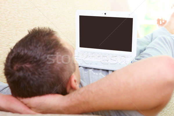 Man relaxing with laptop Stock photo © Amaviael