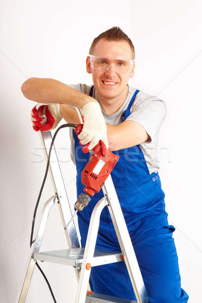 Man boor permanente ladder vrolijk werken Stockfoto © Amaviael