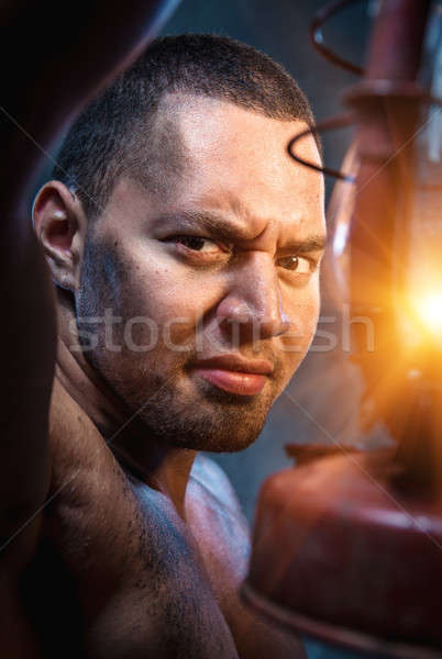 Portrait of young man with oil lamp Stock photo © amok