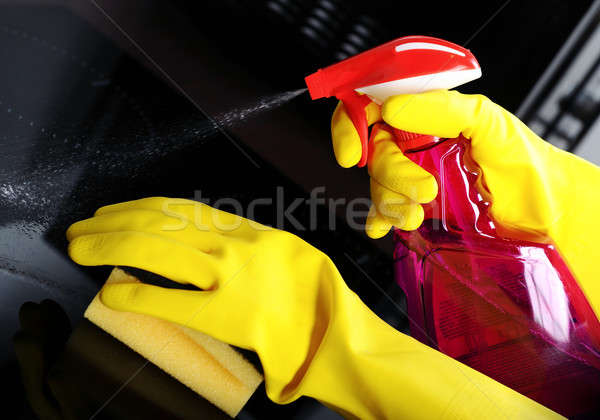 Woman with sponge and rubber gloves cleaning kitchen  Stock photo © amok