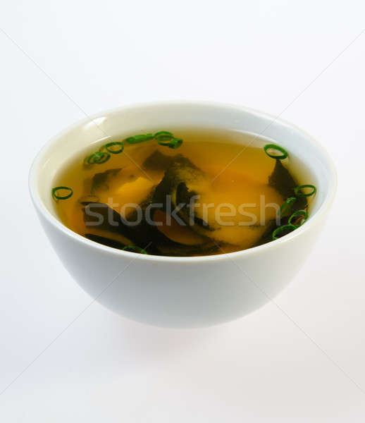 Bowl of fish soup over white background Stock photo © amok