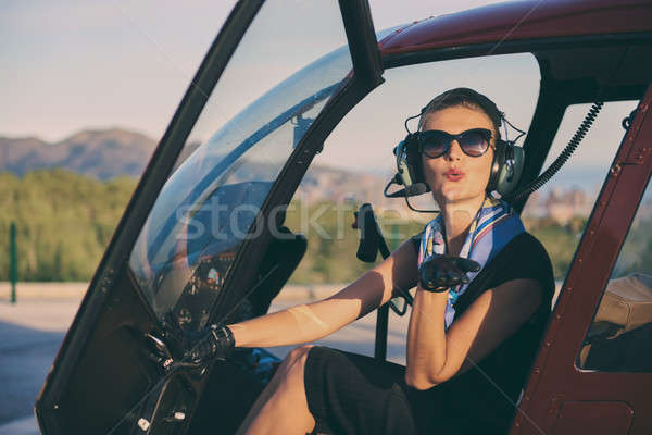 Attractive woman pilot sitting in the helicopter Stock photo © amok