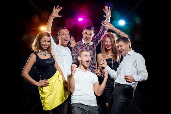 Cheerful group of young people dancing at party Stock photo © amok
