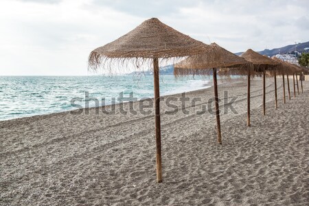 Straw parasols on empty beach. Nerja, Spain Stock photo © amok