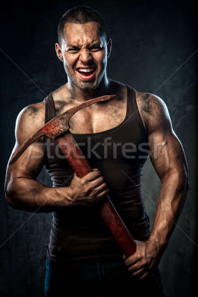 Muscular man holding pickaxe Stock photo © amok