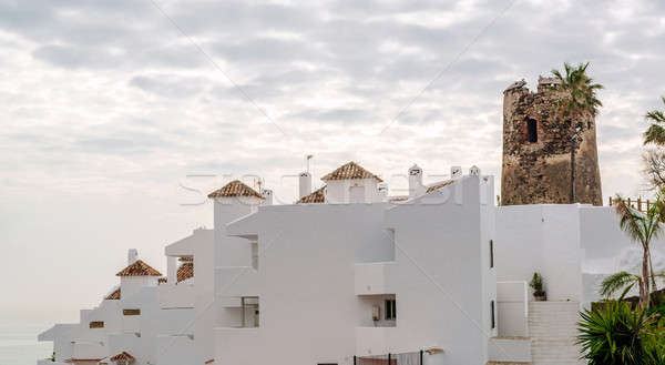 Rooftops of the spanish condominium and tower against cloudy sky Stock photo © amok