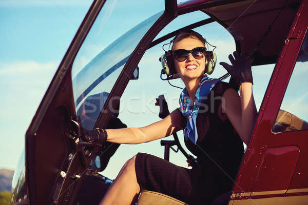 Attractive woman pilot sitting in the helicopter Stock photo © amok