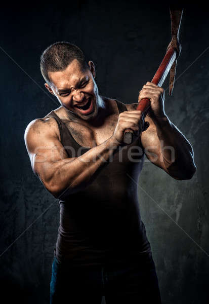 Muscular man holding pickaxe Stock photo © amok