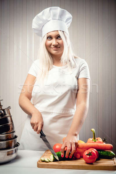Stock photo: Woman wearing uniform cutting vegetables for a salad
