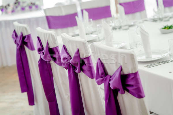 Close-up of white wedding chairs with purple ribbon Stock photo © amok